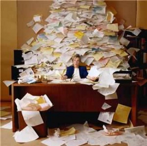 Picture of woman buried under a pile of paper