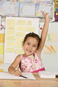 Girl raising hand in classroom